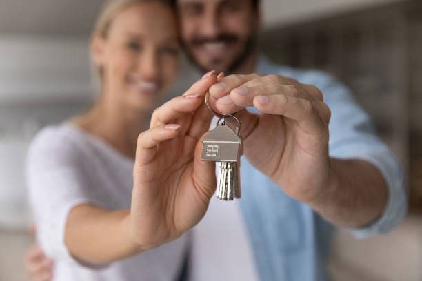 Couple holding keys to first home in Cypress TX — first-time buyer guide